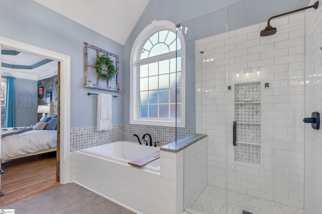 bathroom with tile patterned floors, lofted ceiling, and shower with separate bathtub