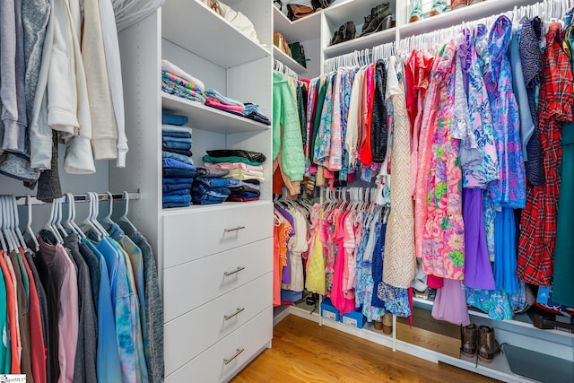 spacious closet with light hardwood / wood-style floors