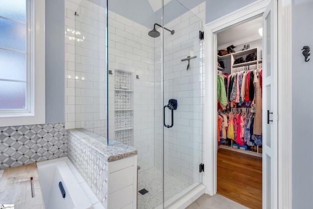 bathroom featuring tile patterned flooring and independent shower and bath