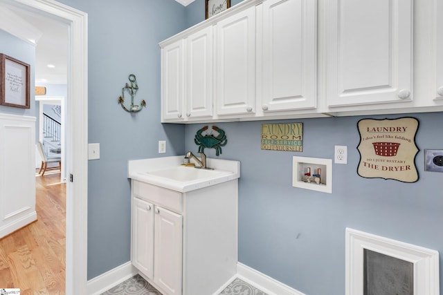 laundry room featuring cabinets, sink, and hookup for a washing machine