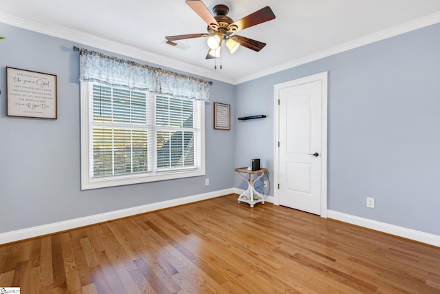 empty room featuring hardwood / wood-style floors, ceiling fan, and ornamental molding