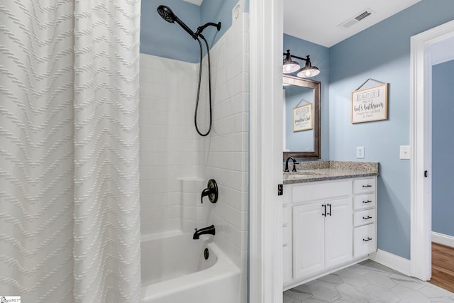 bathroom with tile patterned flooring, shower / bath combo, and vanity