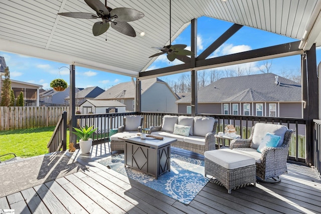 wooden terrace with ceiling fan and an outdoor living space with a fire pit