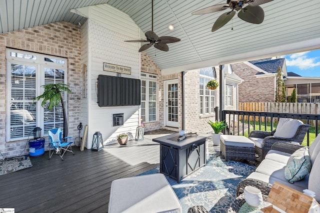 wooden terrace featuring outdoor lounge area and ceiling fan