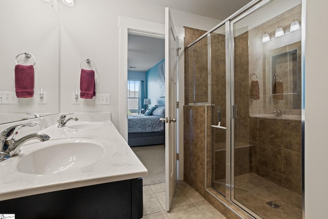 bathroom with tile patterned flooring, vanity, and an enclosed shower