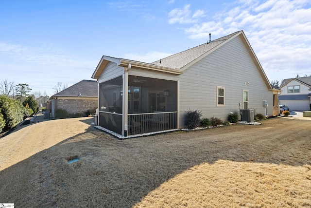 rear view of house with a sunroom and central AC unit