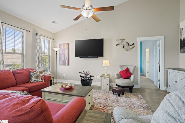 living room featuring hardwood / wood-style flooring, ceiling fan, and lofted ceiling