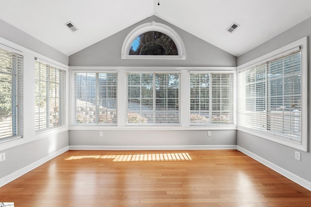 unfurnished sunroom featuring plenty of natural light and lofted ceiling