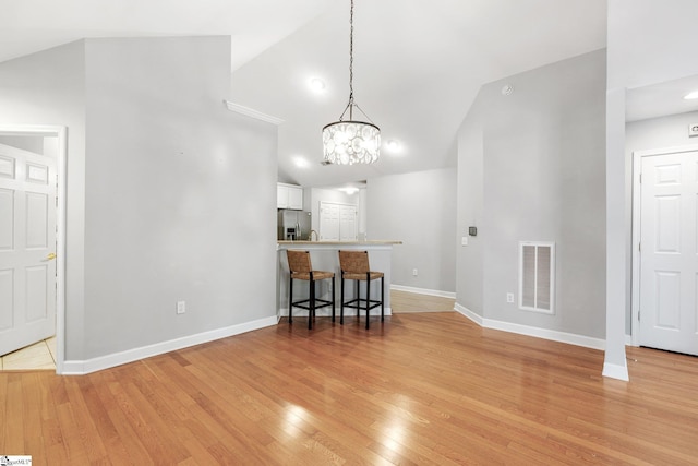 dining room featuring an inviting chandelier and light hardwood / wood-style flooring