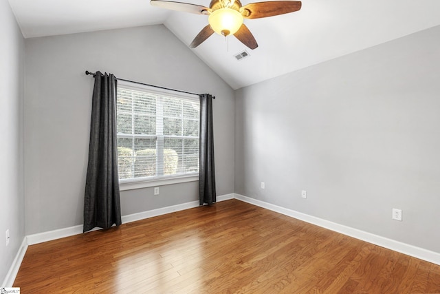 unfurnished room with ceiling fan, hardwood / wood-style floors, and lofted ceiling