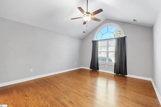 unfurnished room with hardwood / wood-style floors, ceiling fan, and vaulted ceiling