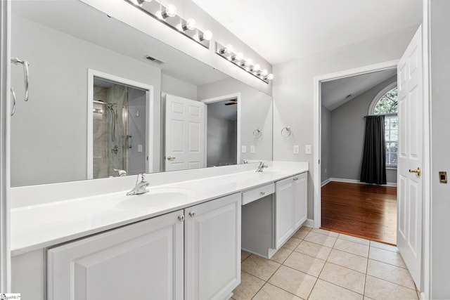 bathroom with tile patterned flooring, vanity, and a shower with door