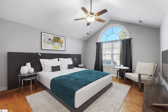 bedroom featuring ceiling fan, light wood-type flooring, and lofted ceiling