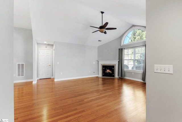 unfurnished living room with ceiling fan, light hardwood / wood-style flooring, and lofted ceiling