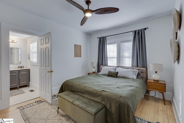 bedroom with multiple windows, ceiling fan, and light hardwood / wood-style floors