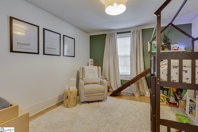 bedroom featuring hardwood / wood-style flooring and ornamental molding