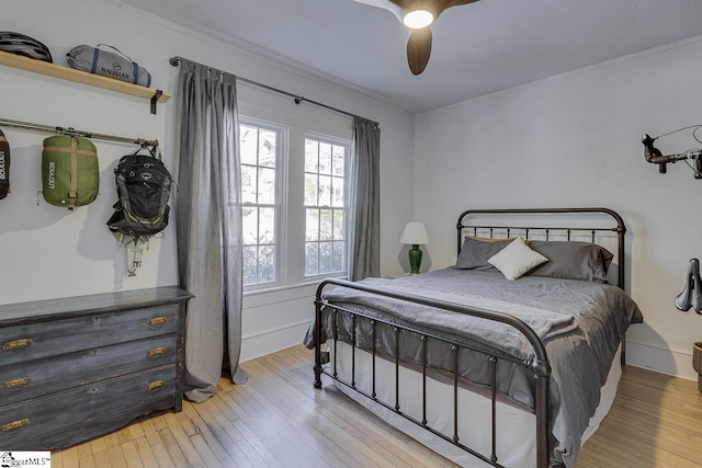 bedroom with ceiling fan, light hardwood / wood-style floors, and ornamental molding