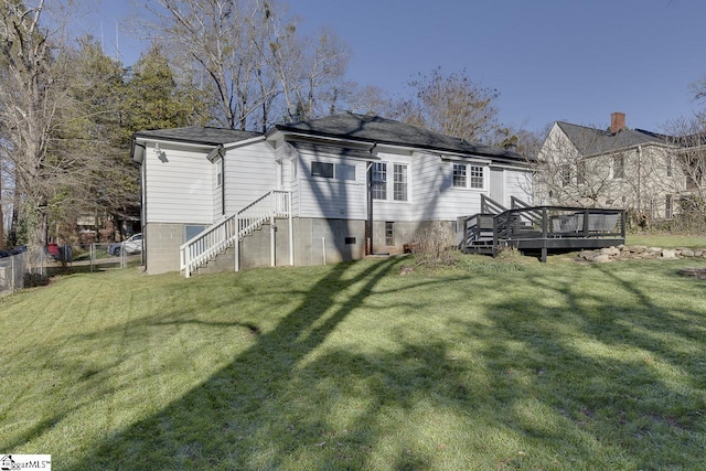 rear view of property with a yard and a deck