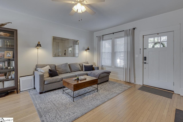 living room featuring ceiling fan and light hardwood / wood-style floors