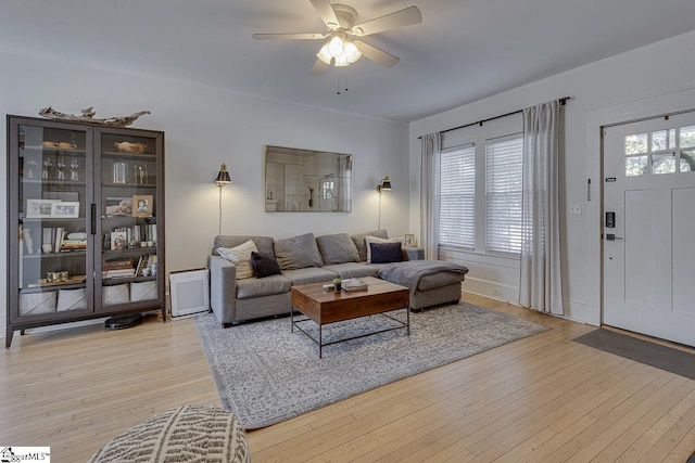 living room featuring light wood-type flooring and ceiling fan