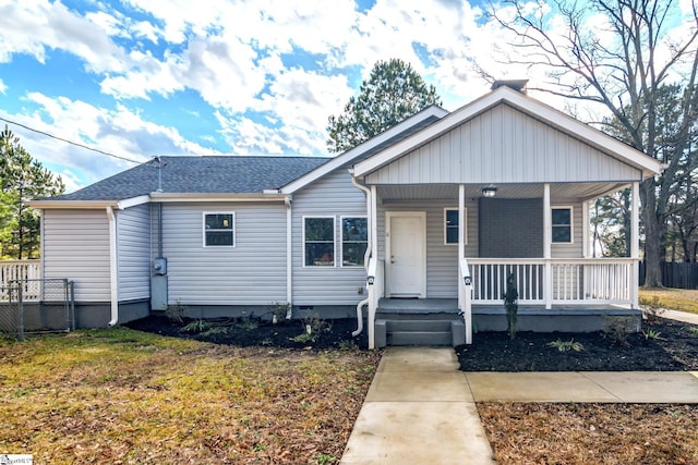 view of front of house with a porch and a front yard