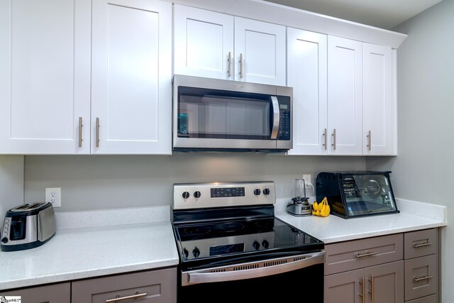 kitchen featuring white cabinetry and stainless steel appliances