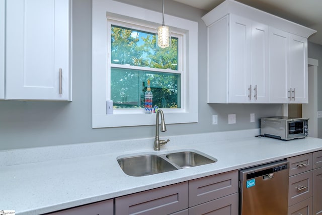 kitchen with white cabinets, dishwasher, pendant lighting, and sink