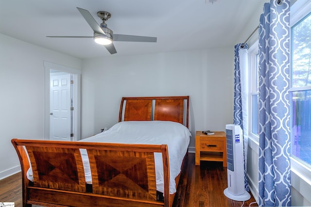 bedroom featuring multiple windows, ceiling fan, and dark hardwood / wood-style flooring