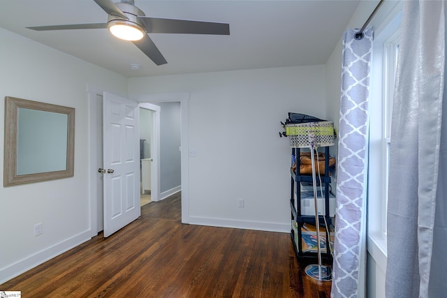 bedroom with dark hardwood / wood-style floors and ceiling fan