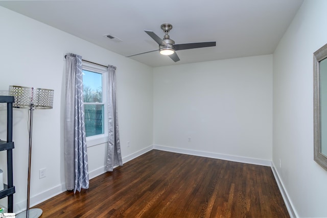 empty room featuring dark hardwood / wood-style floors and ceiling fan