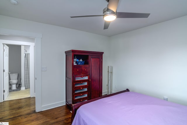 bedroom with ceiling fan, dark hardwood / wood-style flooring, and ensuite bath