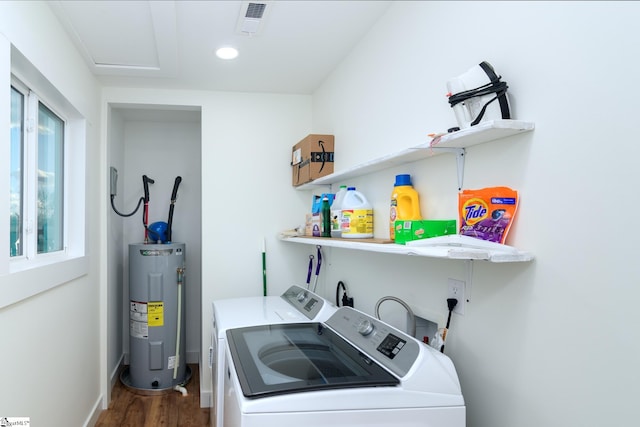 laundry room featuring washer and dryer, dark hardwood / wood-style flooring, and water heater