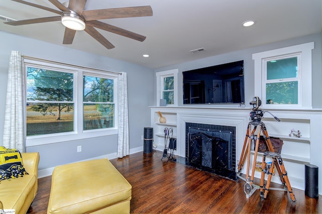 living room featuring dark hardwood / wood-style floors and ceiling fan