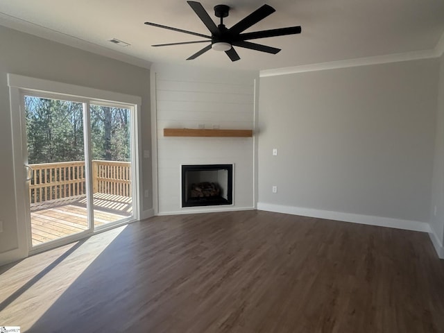 unfurnished living room with crown molding, a fireplace, ceiling fan, and dark hardwood / wood-style floors