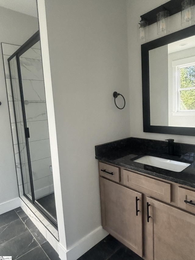 bathroom featuring vanity and a shower with shower door