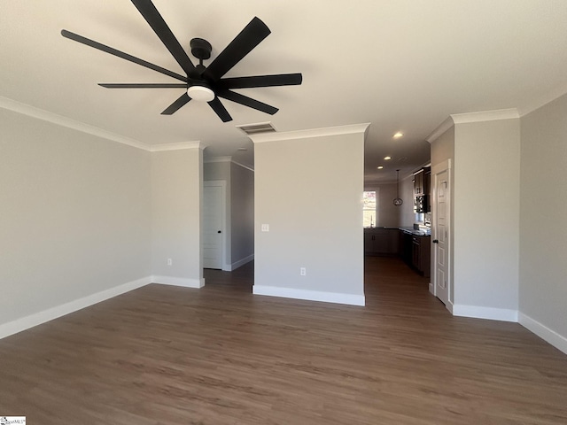 unfurnished living room featuring dark wood-type flooring, ceiling fan, and crown molding