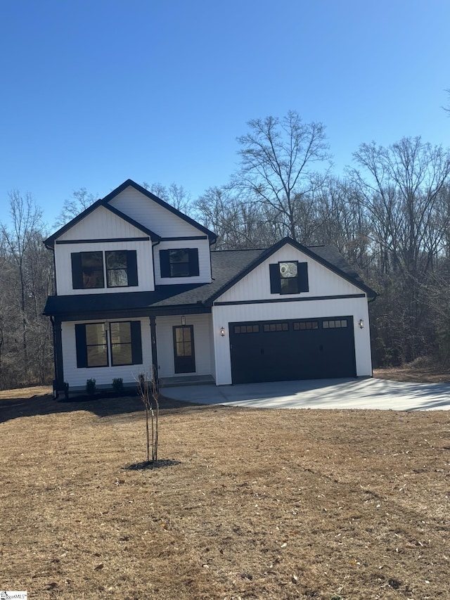 view of front facade featuring a front lawn, a porch, and a garage