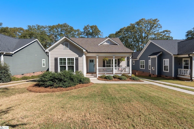 view of front of house with covered porch and a front yard