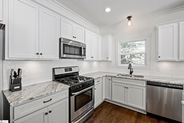 kitchen with white cabinets, light stone countertops, sink, and appliances with stainless steel finishes