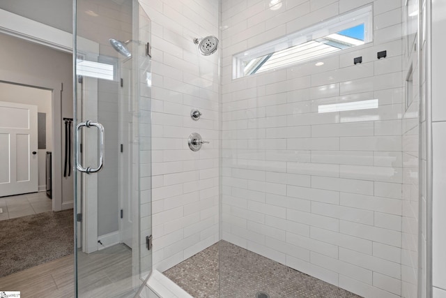 bathroom featuring tile patterned flooring and an enclosed shower