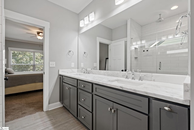 bathroom featuring vanity, crown molding, ceiling fan, and a shower with shower door