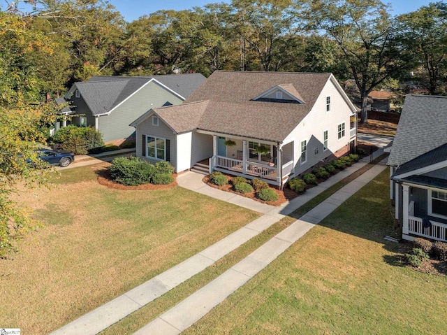 view of front facade featuring a front lawn and covered porch