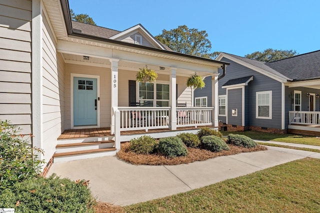 property entrance featuring a yard and a porch