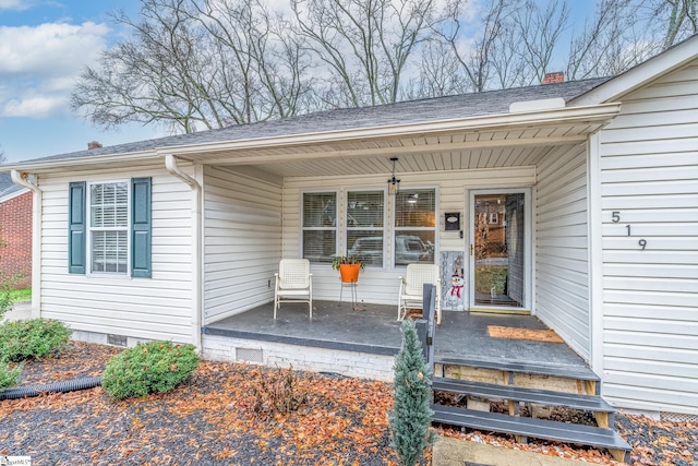 view of exterior entry featuring covered porch