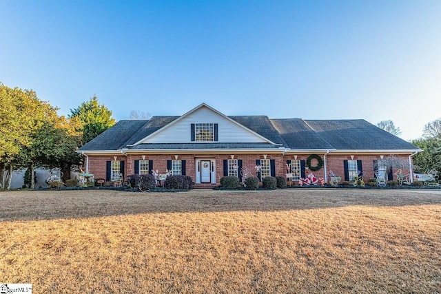 view of front of property with a front lawn and brick siding