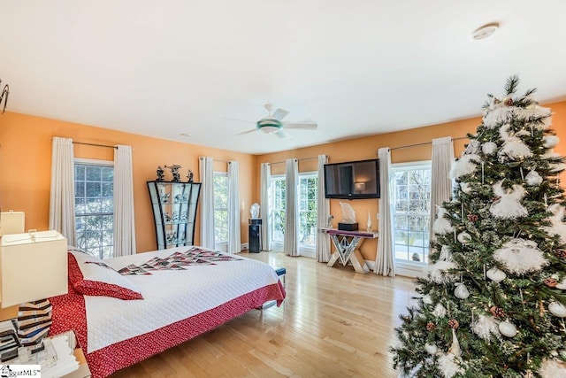 bedroom with access to outside, ceiling fan, and hardwood / wood-style flooring