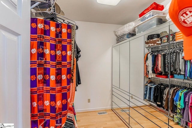 spacious closet featuring hardwood / wood-style floors