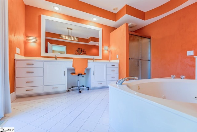 bathroom with a tub, tile patterned flooring, and vanity