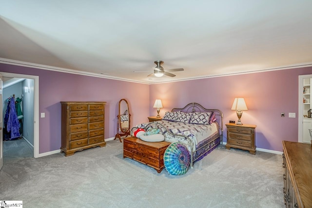 carpeted bedroom featuring ceiling fan, crown molding, and a closet