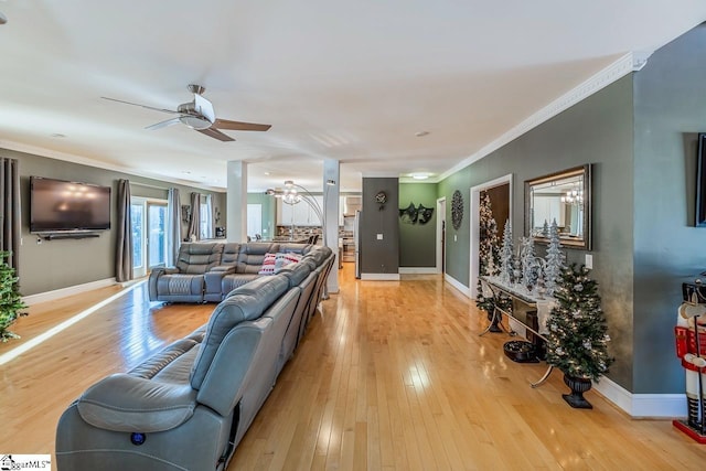 living room featuring ceiling fan, light hardwood / wood-style flooring, and ornamental molding